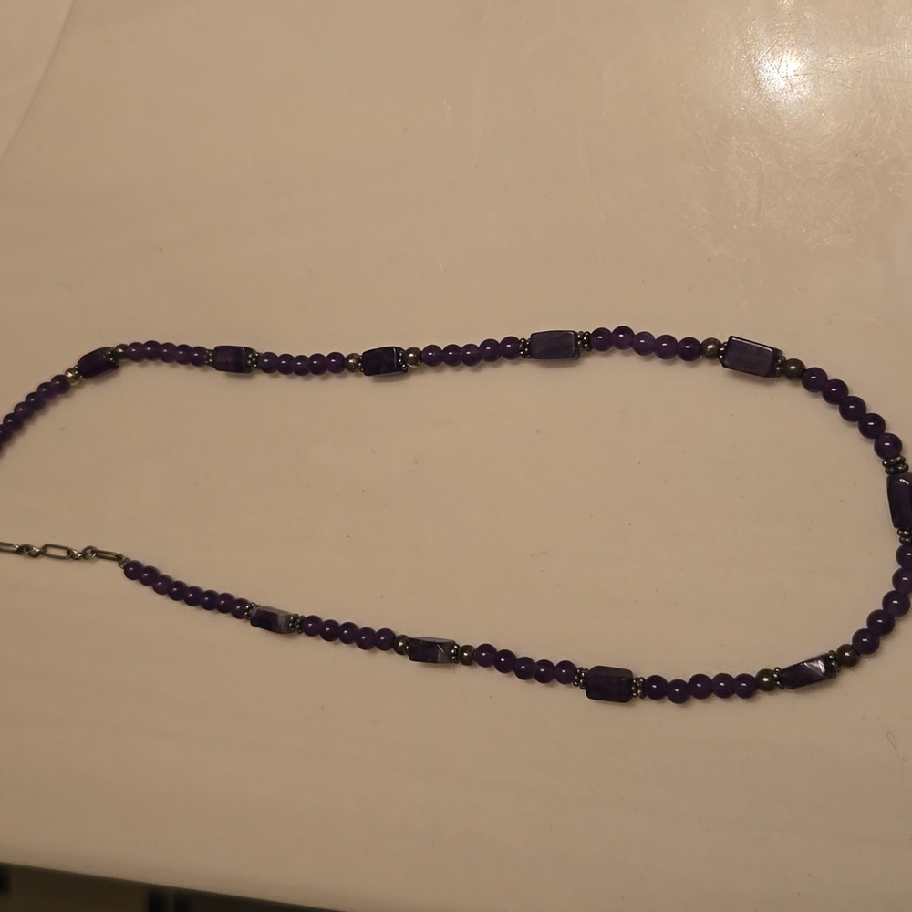 An amethyst bead necklace.